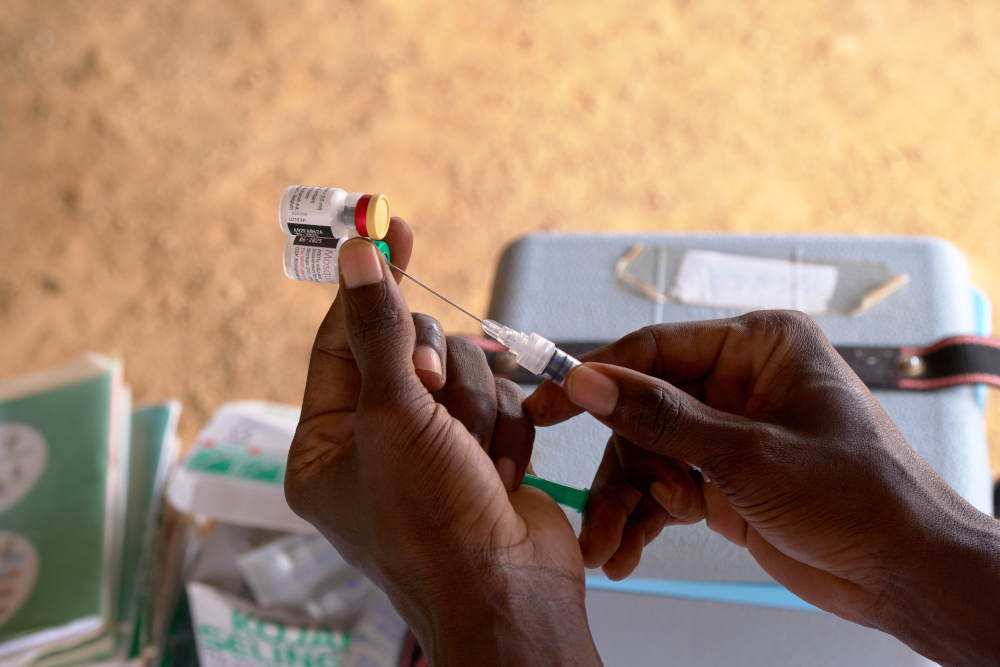 A health worker in Gyabankrom, Ghana, prepares a malaria vaccine.