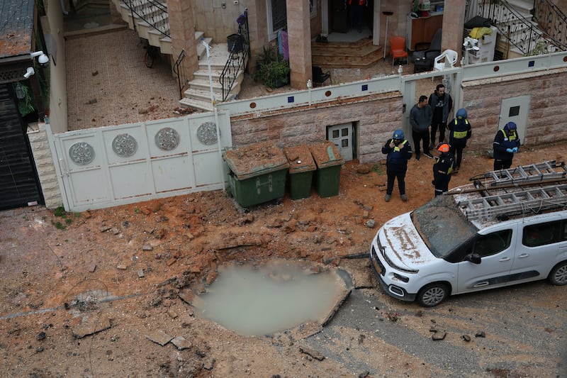 Israeli rescuers and security personnel survey the site struck by a projectile in the Arab-Israeli city of Kfar Qassem on Thursday. Photograph: Ilia Yefimovich/AFP via Getty Images