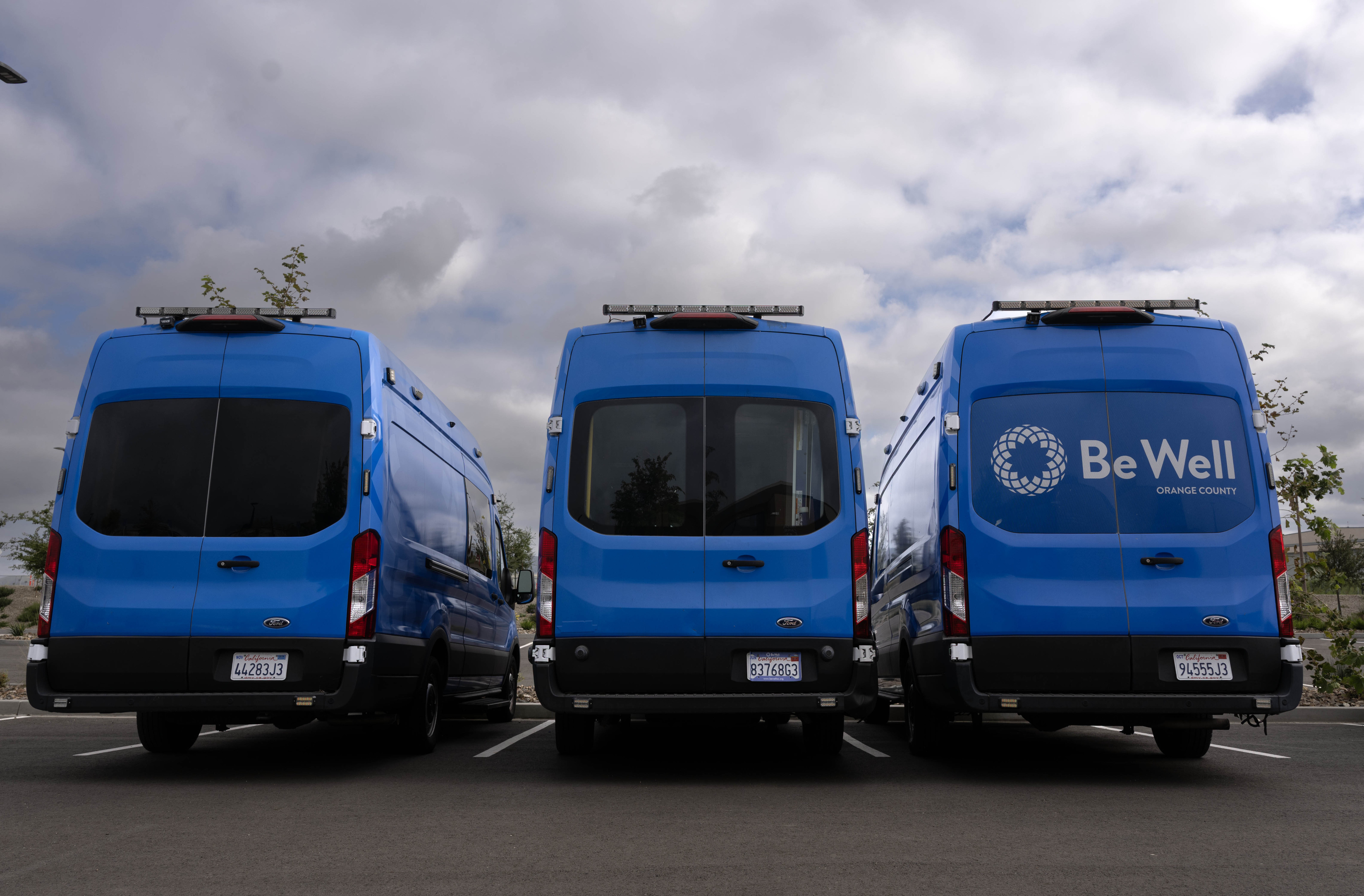 Be Well vans are parked outside the new Be Well...