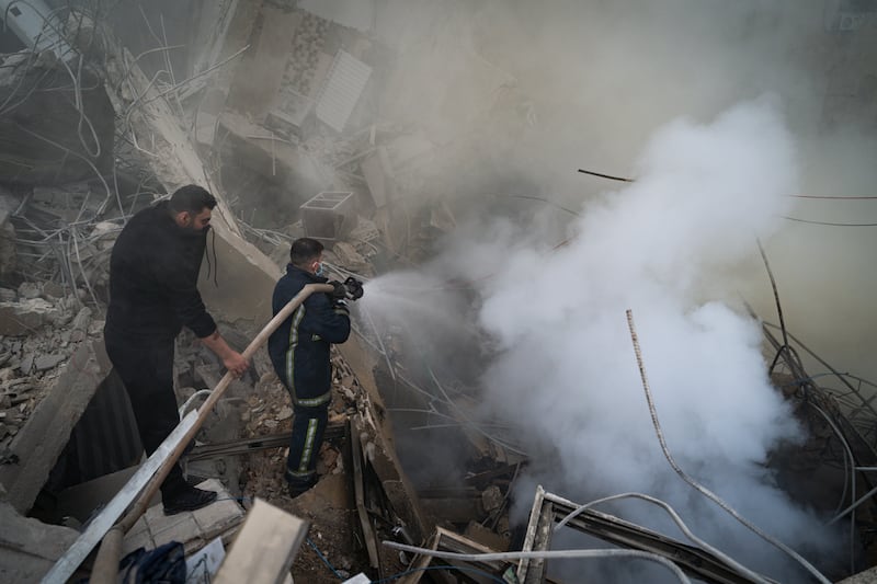 Firefighters work to extinguish a fire on a building that has collapsed after an IDF air strike in Beirut, Lebanon. Photograph: Adri Salido/Getty Images