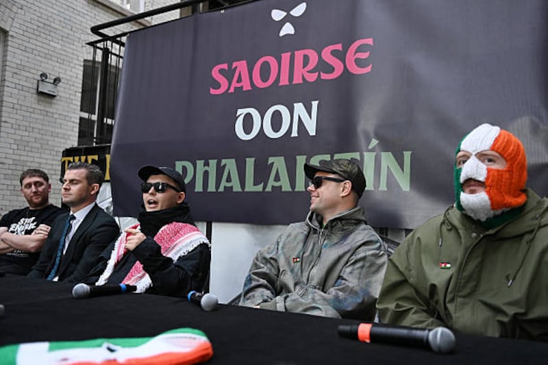 (2nd L-R) Lawyer Darragh Mackin and Liam Óg Ó hAnnaidh, aka Mo Chara, Naoise Ó Cairealláin, aka Móglaí Bap and J. J. Ó Dochartaigh, aka DJ Próvaí, of the band Kneecap attend a press conference following a High Court ruling which upheld the decision to drop the terrorism case against Liam Og O hAnnaidh. Photo by Charles McQuillan/Getty Images