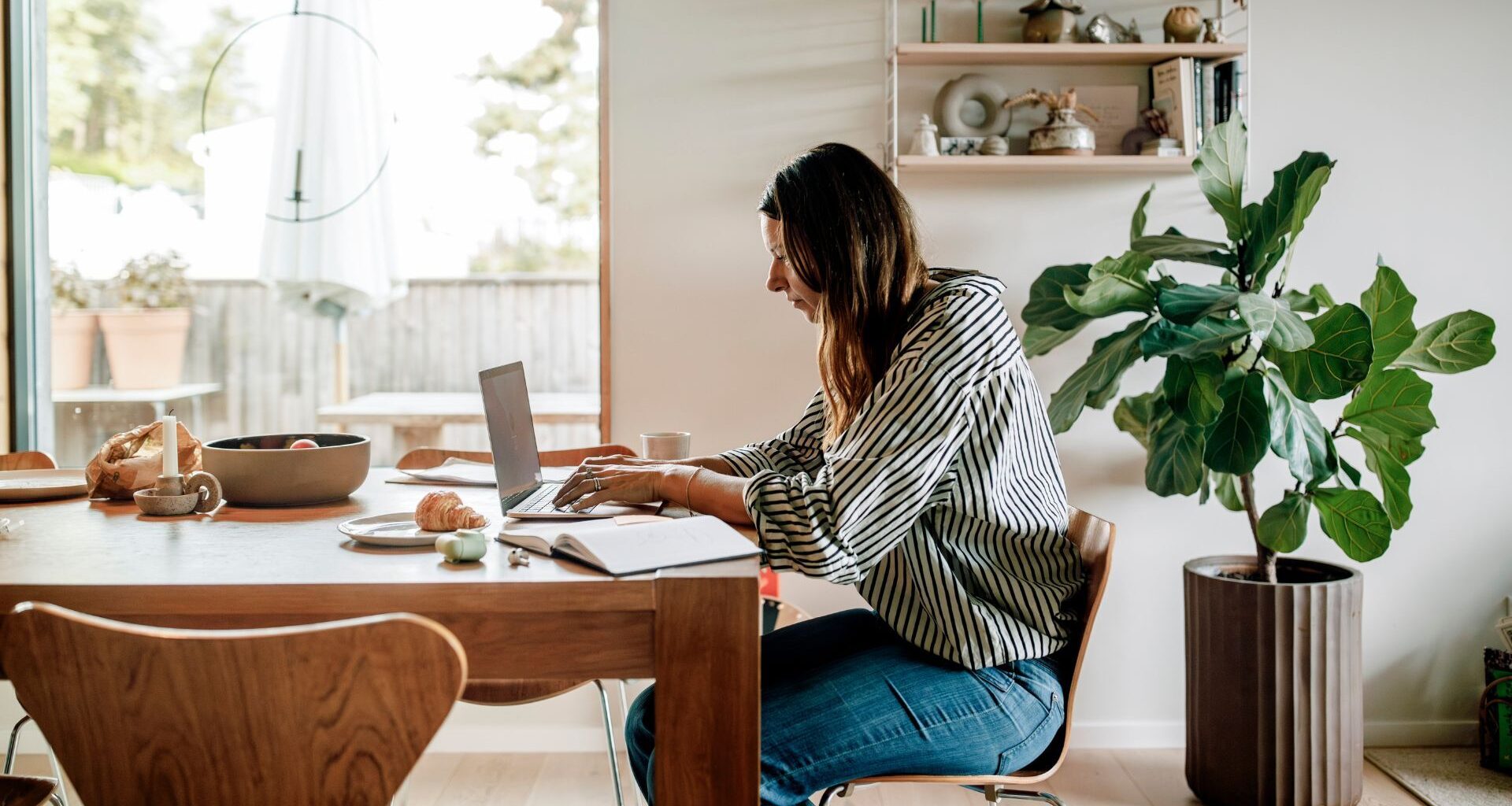 Woman sitting at desk looking at laptop
