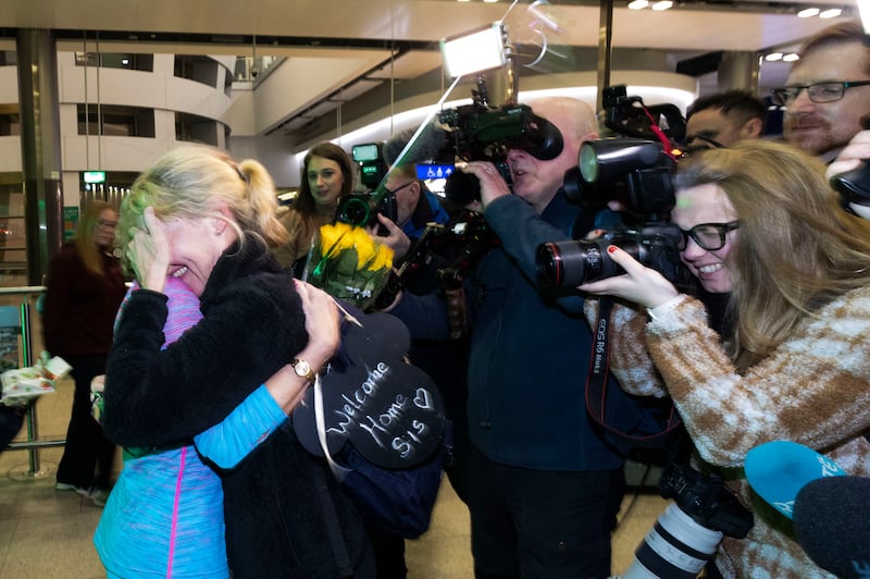 Elaine Gleeson welcomes home her sister Nora Geary from Limerick to Dublin Airport, on the first Emirates flight to have left Dubai International Airport since the no fly zone due to the Iran/US War. Photograph: Sam Boal/Collins Photos 
 