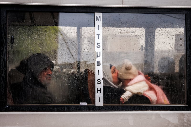 A woman holds a child as she rides in a bus in central Beirut on Thursday. Photograph: by Dimitar Dilkoff/AFP via Getty Images