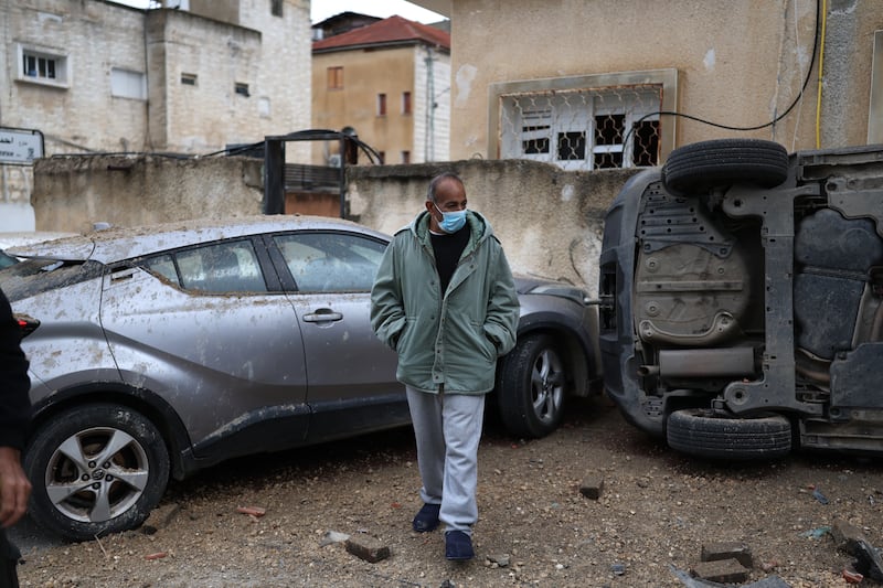 A man surveys the damage at the site struck by a projectile in the Arab-Israeli city of Kfar Qassem on Thursday. Photograph: Ilia Yefimovich/AFP via Getty Images 