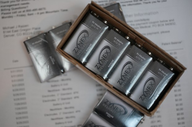 Bills and a box of batteries from Zynex at Michael Raizen's home in Denver on Wednesday, Feb. 18, 2026. (Photo by Hyoung Chang/The Denver Post)