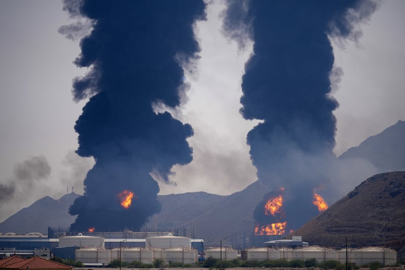 Plumes of smoke and fire rise after debris from an intercepted Iranian drone struck an oil facility, according to authorities, in Fujairah, United Arab Emirates (Altaf Qadri/AP)