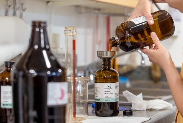 Clinical herbalist Hao Le mixes herbal extracts for a healing tincture at Farmacopia, an herbal apothecary Friday, March 20, 2026 in Santa Rosa. (John Burgess/The Press Democrat)