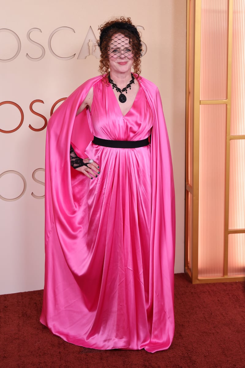 Hamnet author Maggie O'Farrell wearing a fuchsia gown with a black headpiece and matching gloves. Photograph: Julian Hamilton/Getty Images