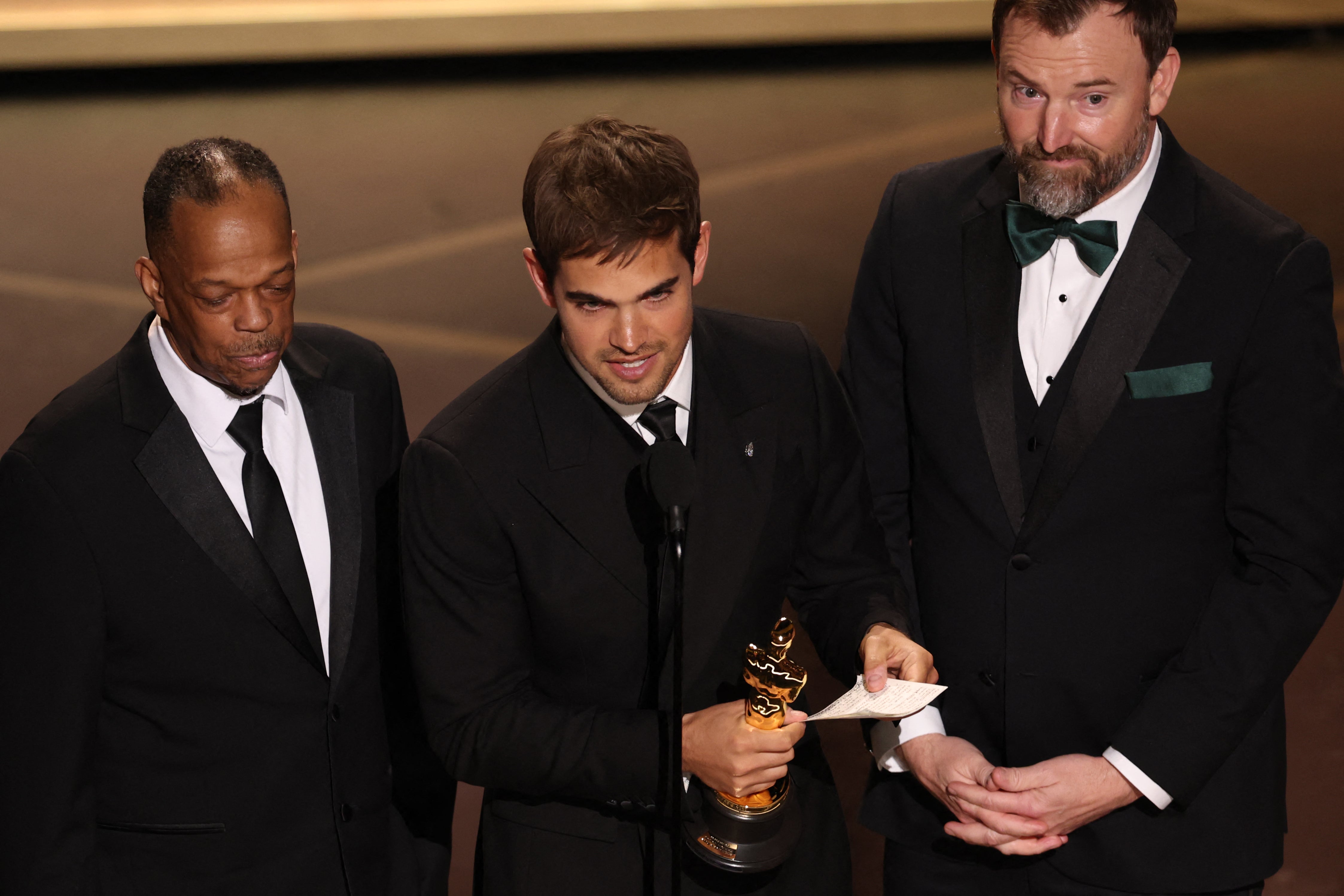 Filmmakers Sam Davis (middle) and Jack Piatt (right) accepted the award for Best Live Action Short Film for 'The Singers'