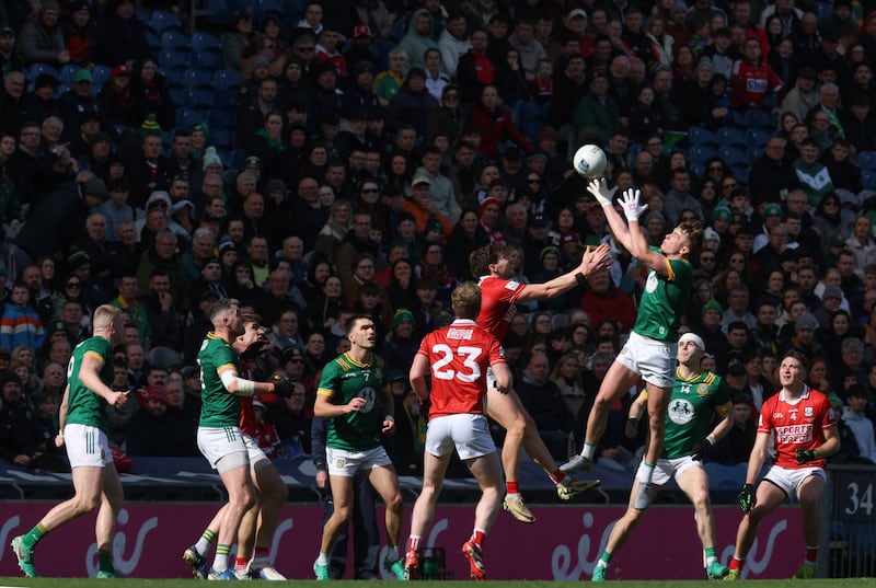 Meath's Ruairí Kinsella fields a high ball under pressure from Cork's Paul Walsh during Sunday's NFL Division 2 final. Photograph: Tom Maher/Inpho