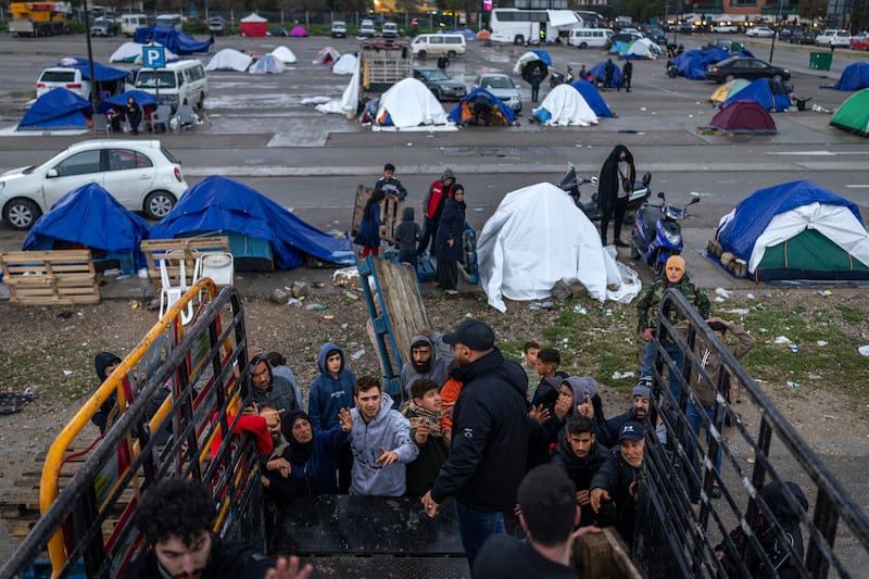 A group of Lebanese internally displaced people gathers around a truck to collect water in Beirut, March 21st, 2026. Photograph: Diego Ibarra Sánchez/The New York Times.