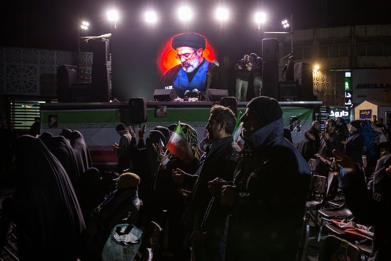 People in front of a picture of Mojtaba Khamenei, the son and successor to the late supreme leader Ayatollah Ali Khamenei, in Tehran, Iran, on March 9th, 2026. Photograph: Arash Khamooshi/the New York Times