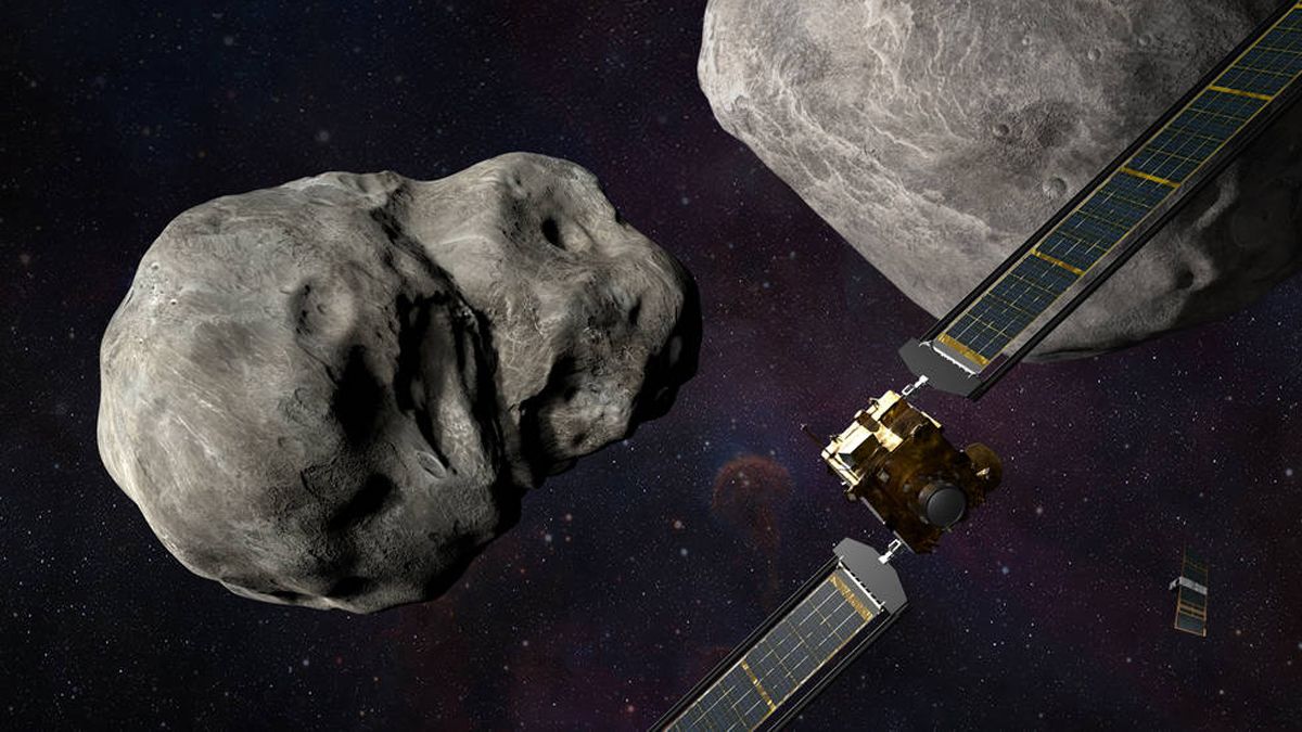 A box-shaped spacecraft with solar wings approaching two space rocks.