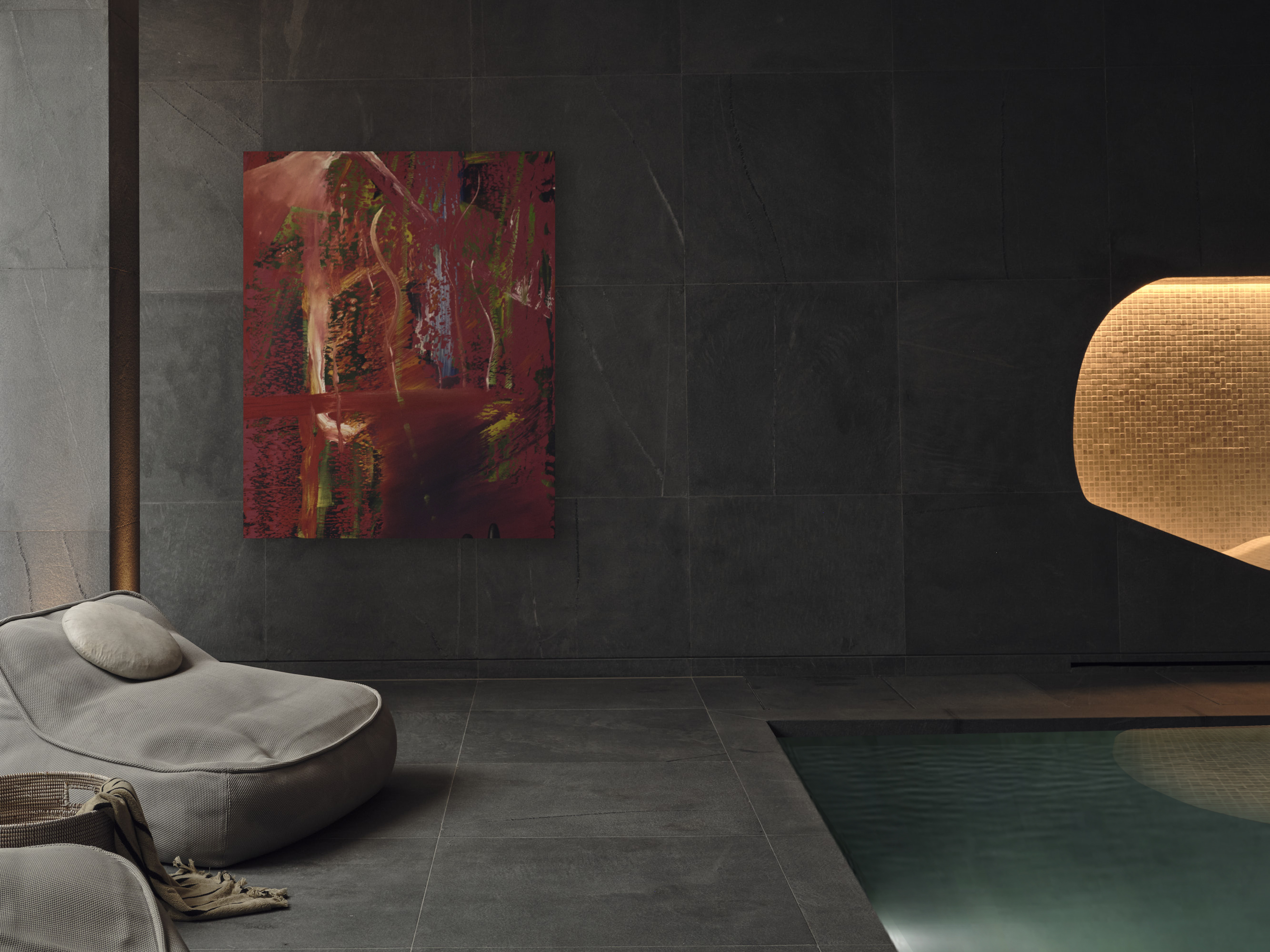 indoor pool with grey tiles on floors and walls, large artwork, and grey poolside seats