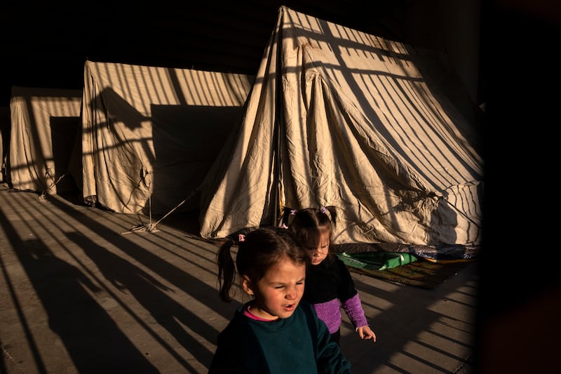 Sisters play near their family’s tent inside the Camille Chamoun Sports City Stadium, which is occupied by displaced people, in Beirut, Lebanon, on Wednesday. Photograph: David Guttenfelder/The New York Times
                      