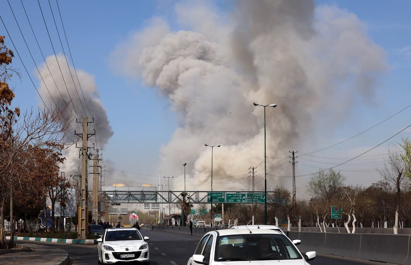 People run for safety as smoke rises after an airstrike in central Tehran, Iran, March 5th, 2026. Photograph: EPA
