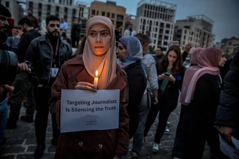 A woman holds up a poster saying 'targeting journalists is silencing the truth' during a protest in Martyrs' Square, Beirut, hours after the three journalists were targeted and killed in southern Lebanon. Photograph: Sally Hayden