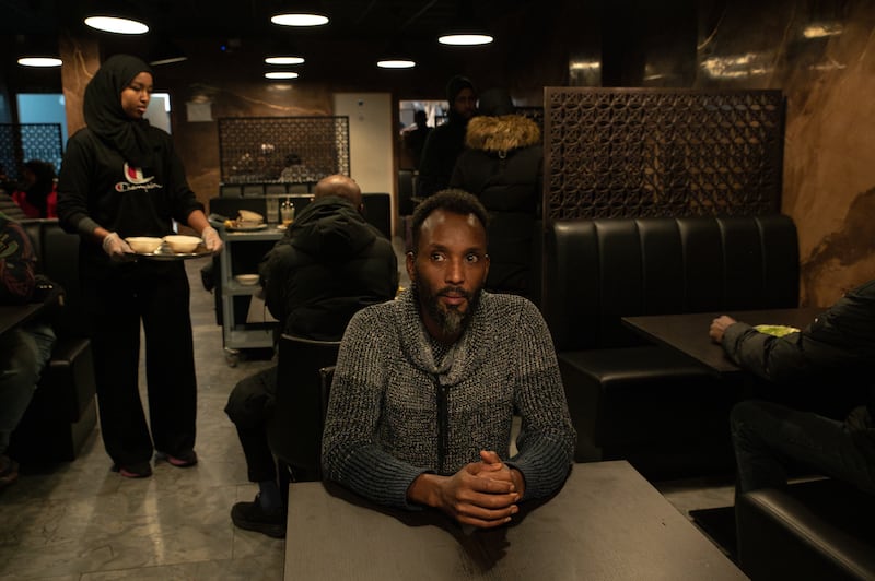 Abudullahi Ali, the owner, pictured at Marka Cadey Halal Food on Talbot Street in Dublin, with staff and a customer in the background. All photos: Natalia Campos for The Irish Times