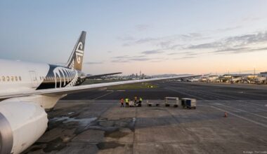 Air New Zealand widebody aircraft on the tarmac at Auckland Airport at dusk.