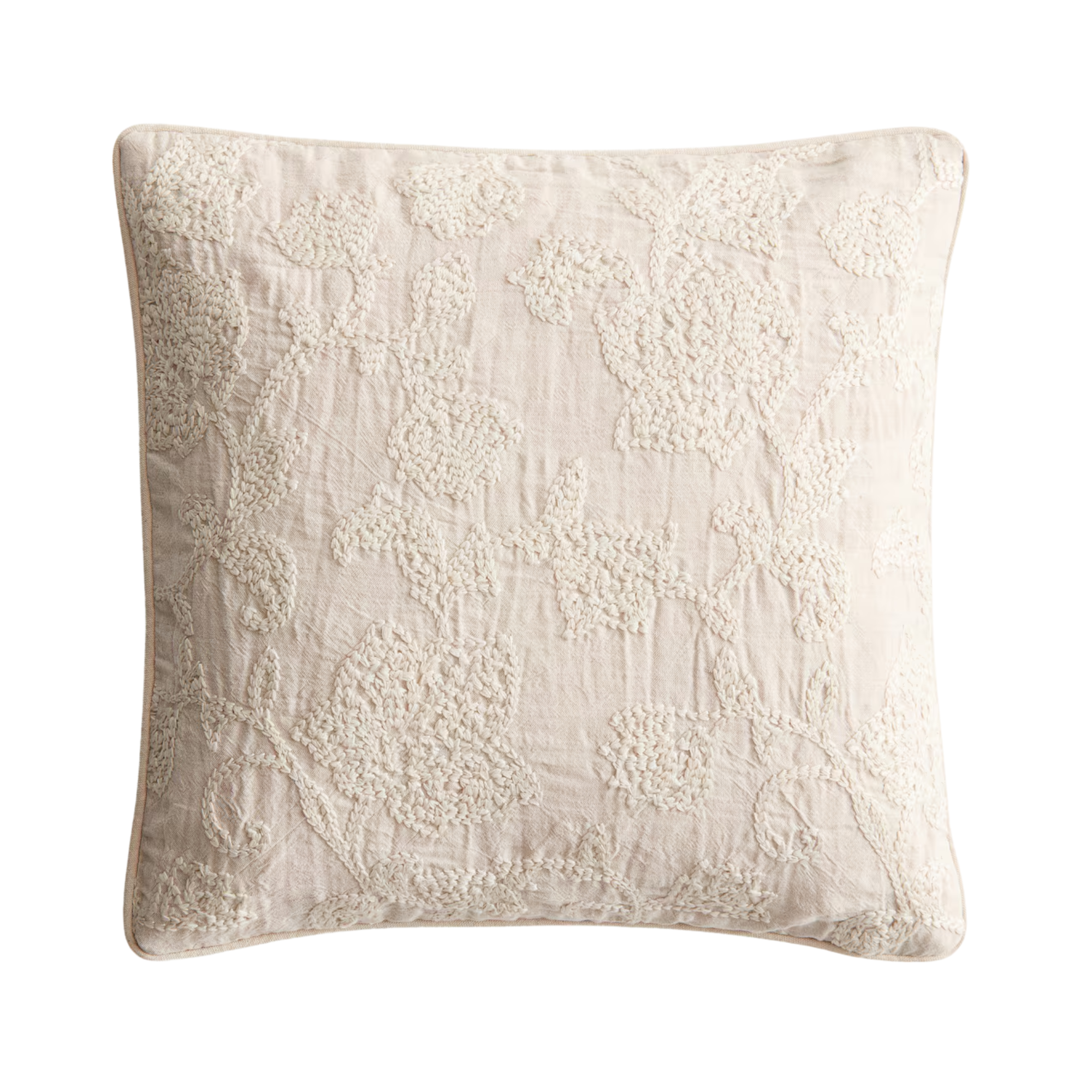 a white embroidered throw pillow