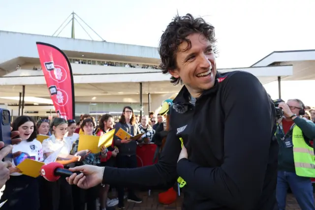 Greg holds a microphone at the Day 5 finish line in York