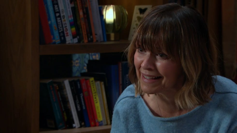 person sitting in a cozy setting with books in the background