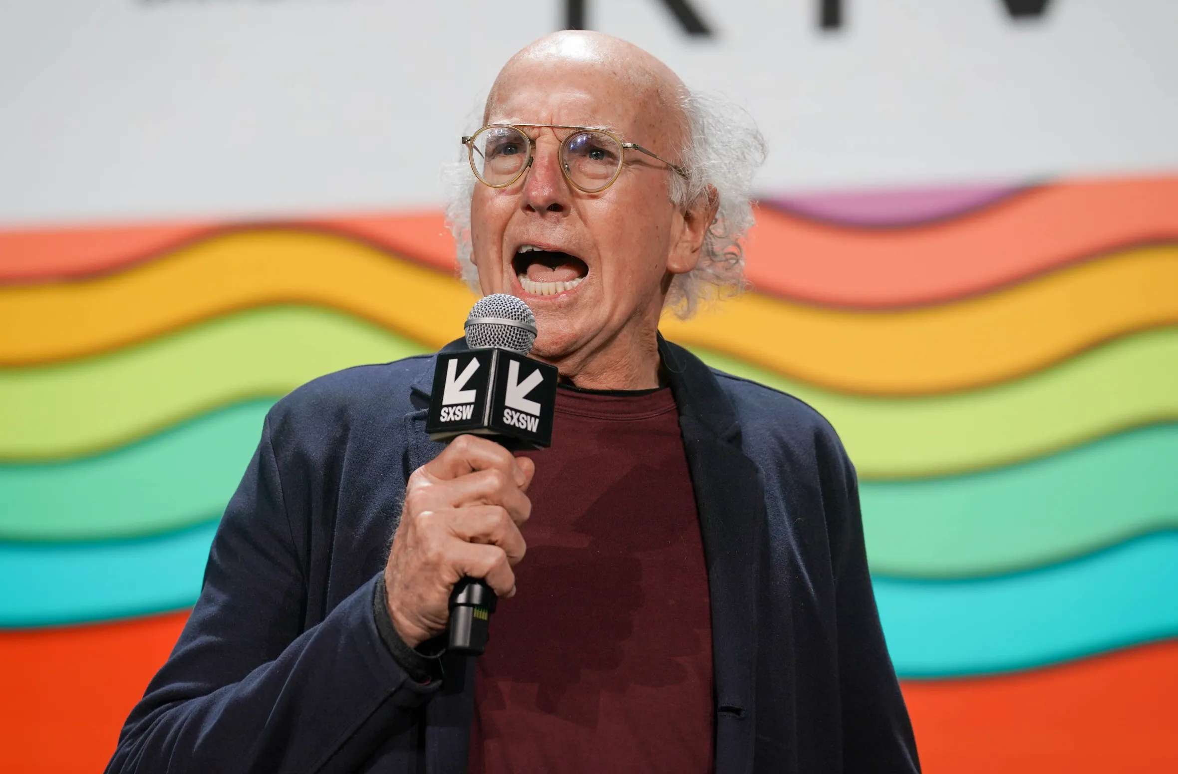 Larry David speaking onstage at the SXSW Conference and Festival.