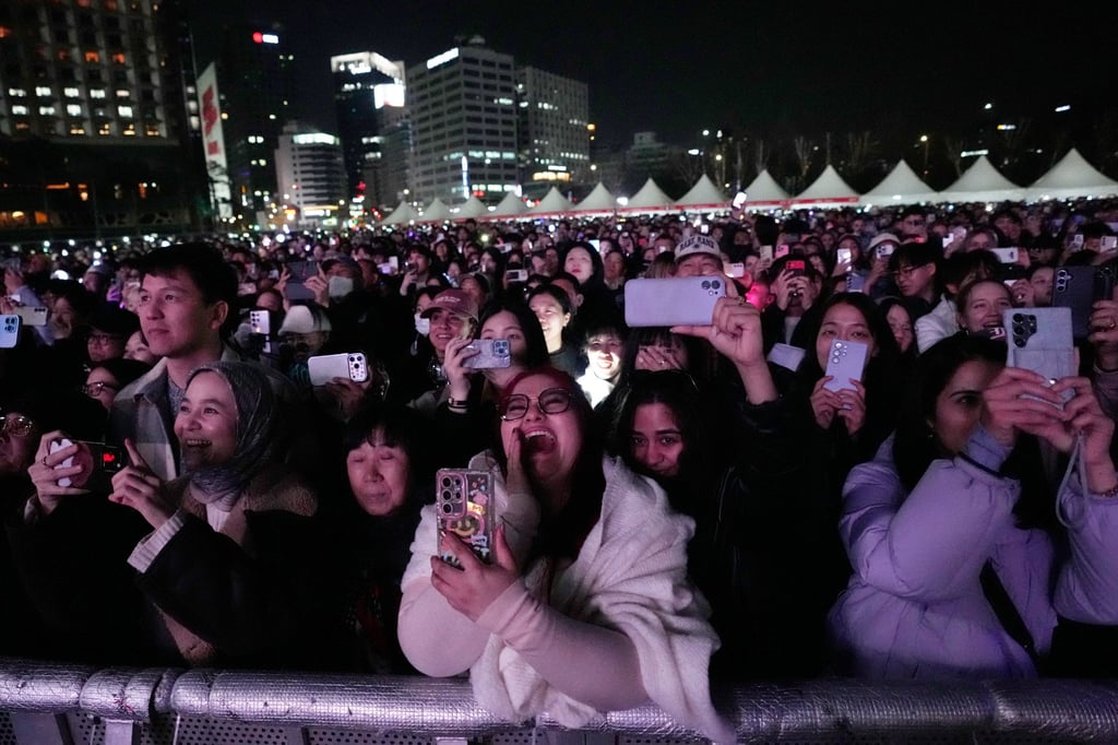 Fans react during BTS’ comeback concert near Gwanghwamun Square in Seoul on Saturday. Photo: AP