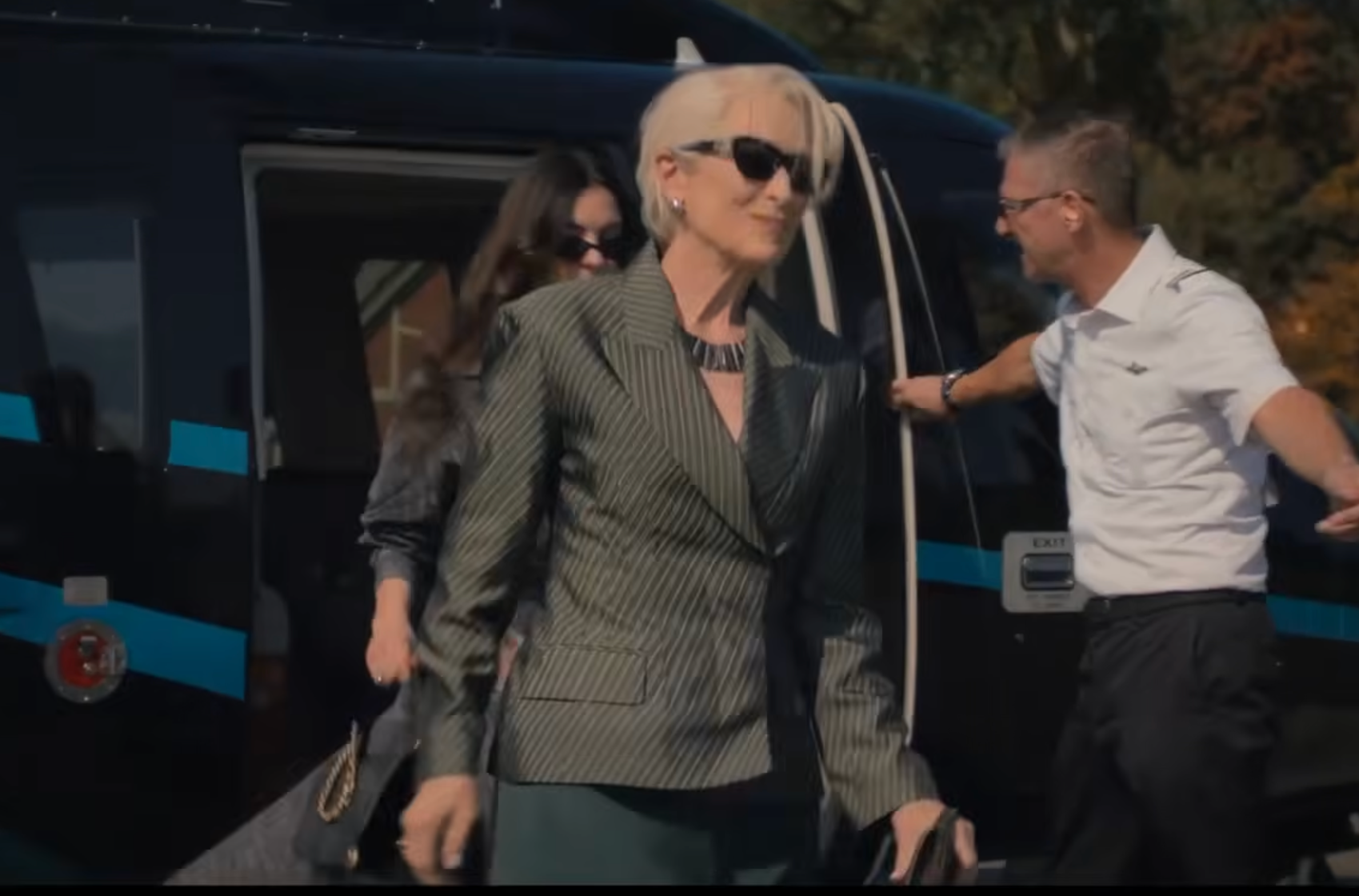 group of people exiting a helicopter