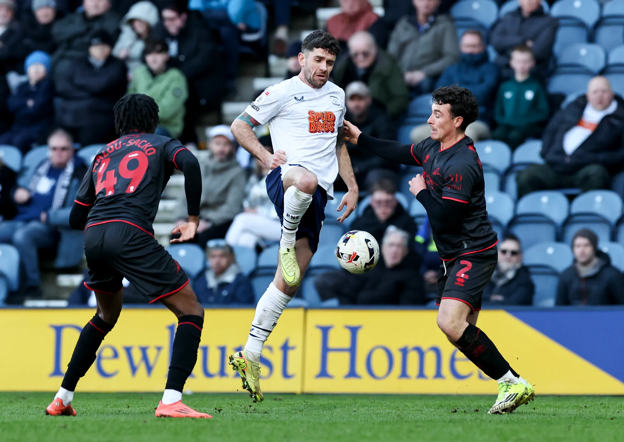 Preston North End's Robbie Brady controls the ball under pressure from Millwall's Dan McNamara and Derek Mazou-Sacko during a Sky Bet Championship match.