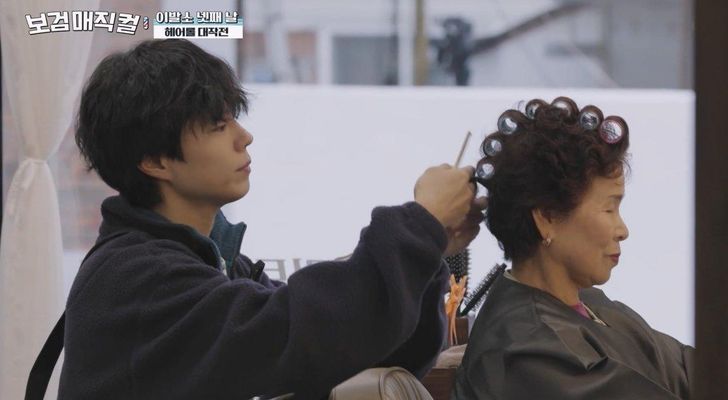 Park Bo-gum, left, is seen styling hair in the tvN’s reality show 'The Village Barber.' Courtesy of CJ ENM