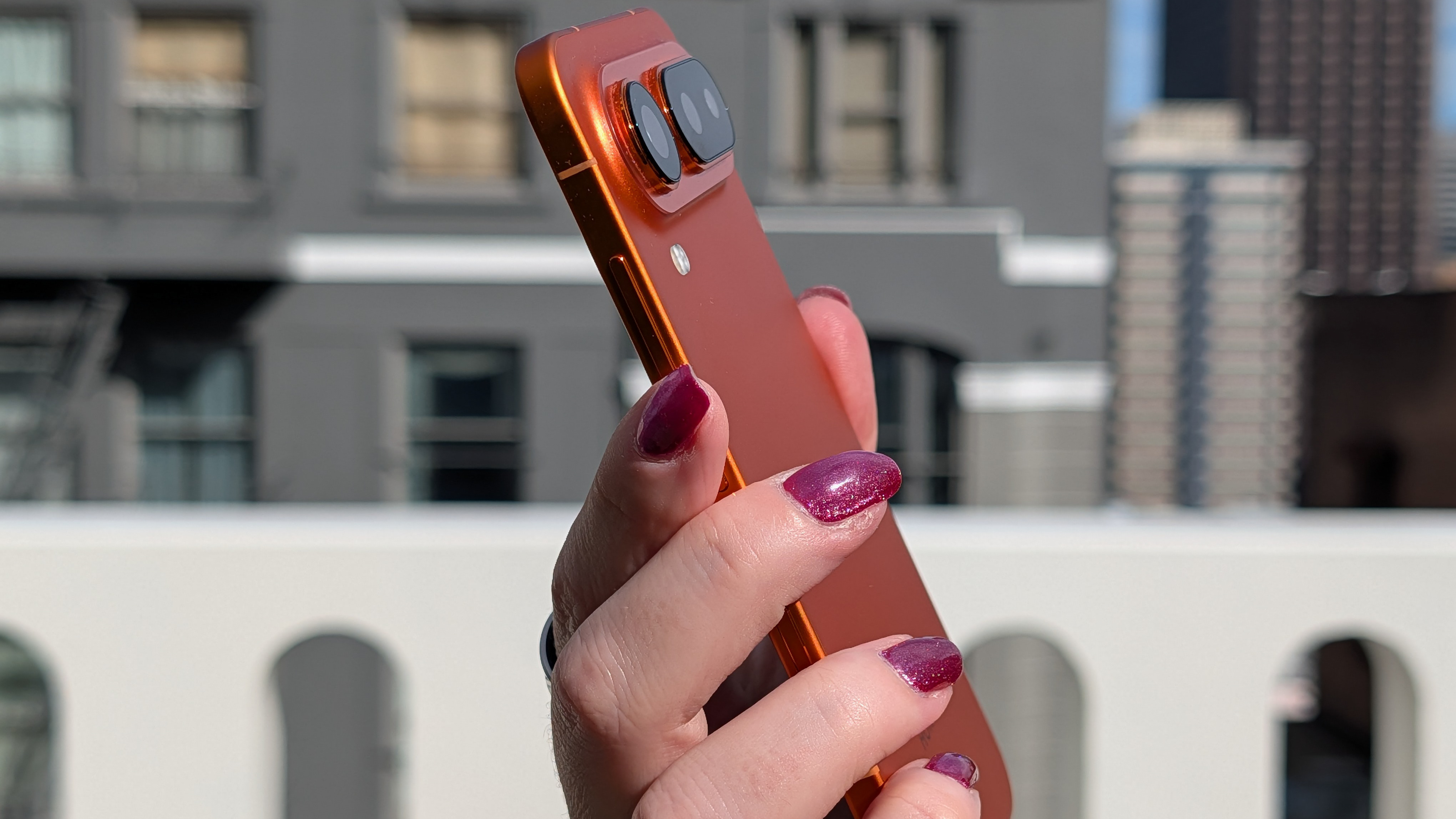 The Honor Magic 8 Pro Air in orange in the hand