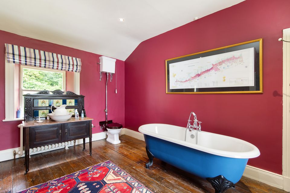 The bathroom at Ely Lodge comes with a stand alone tub