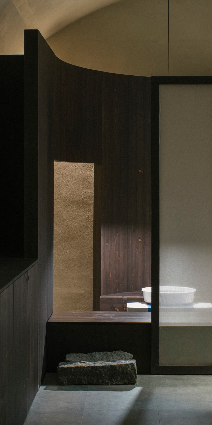 perforated wooden screens filter light and shadow within milan ceramic workshop - 6