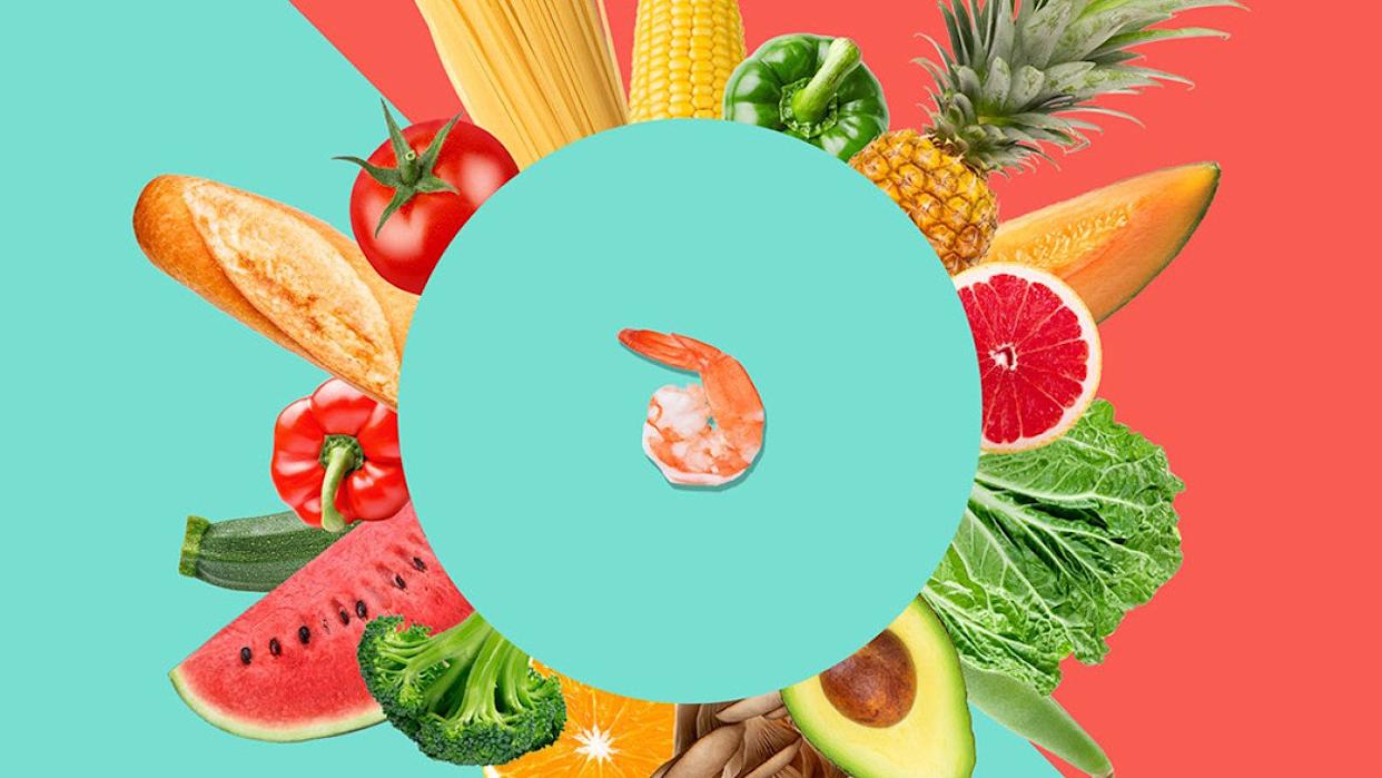 Bread, grains, fruits, and vegetables arranged in a circular pattern around a shrimp at the center. - Knowable Magazine