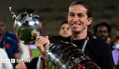 Filipe Luis poses with the Copa Libertadores trophy