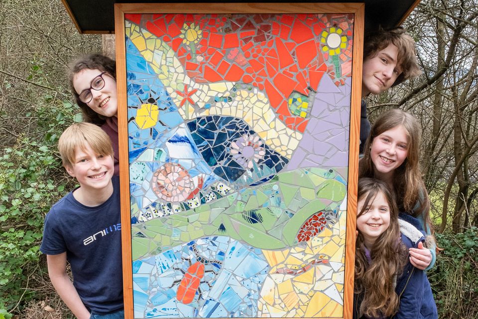 Evan and Aaron Cullen, Sylva and Theia Sepight Murphy, and Sophie Schriever alongisde one of the mosaics they worked on.