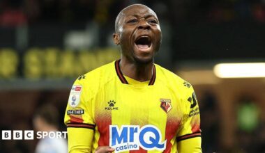 Marc Bola of Watford (centre) celebrates scoring against Wrexham with team-mates Nestory Irankunda (right) and Edo Kayembe (left)