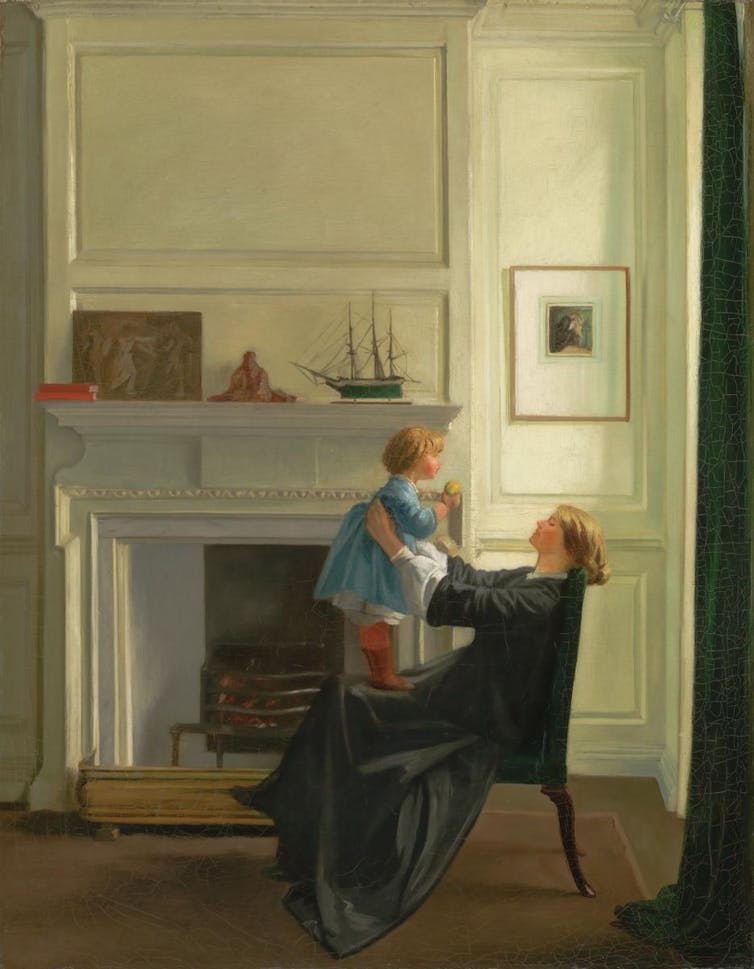 A mother holding her child in front of her