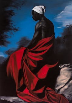 Portrait of a black man facing away, wrapped in a luxurious red robe.