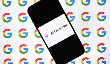 A cellphone with an image on it that reads AI Overview. The AI sparkle precedes the words.