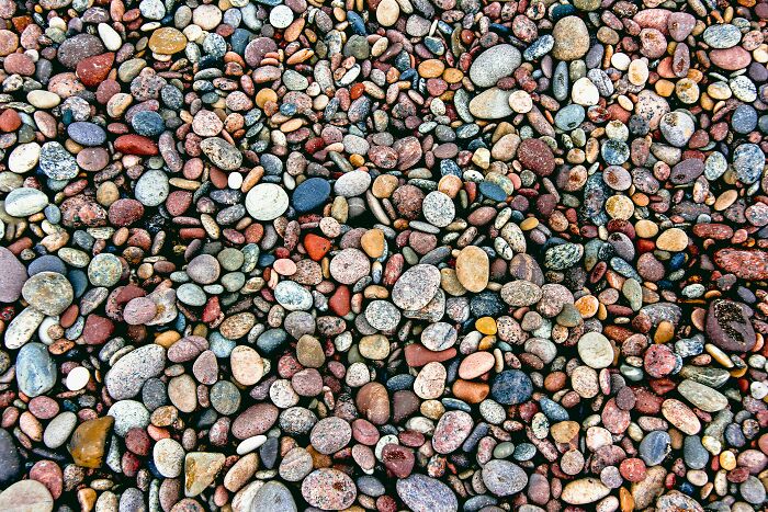 Colorful mixed pebbles of various shapes and sizes, illustrating the concept of patients faking symptoms in medical cases.