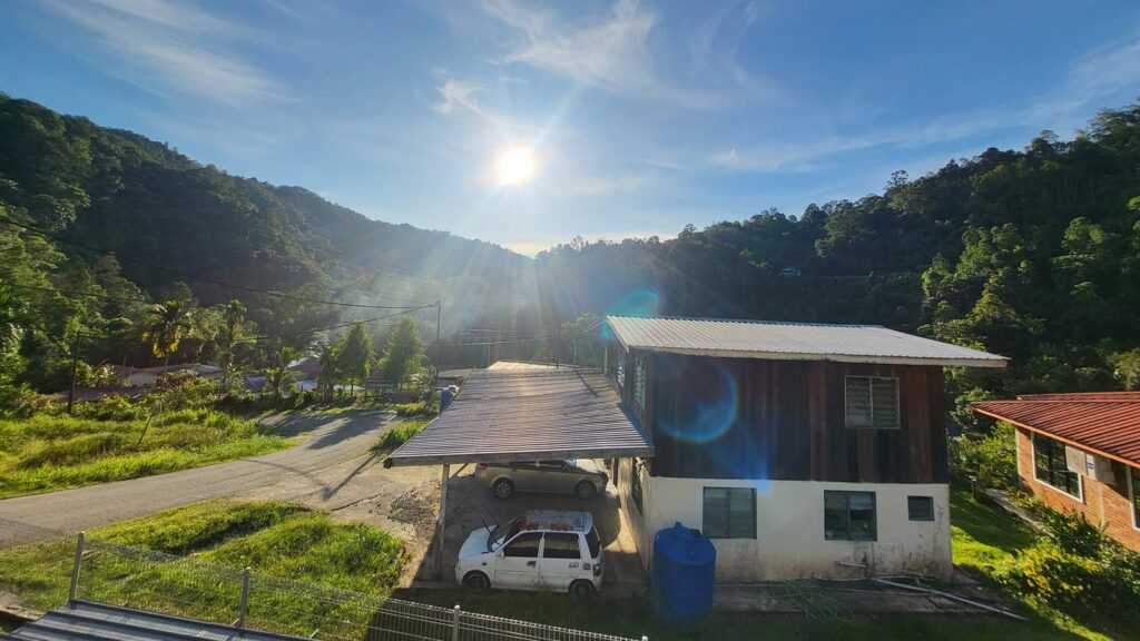 Intense sunlight and hot weather conditions in Sabah, Malaysia, illustrating the visible effects of an accelerating global warming rate.