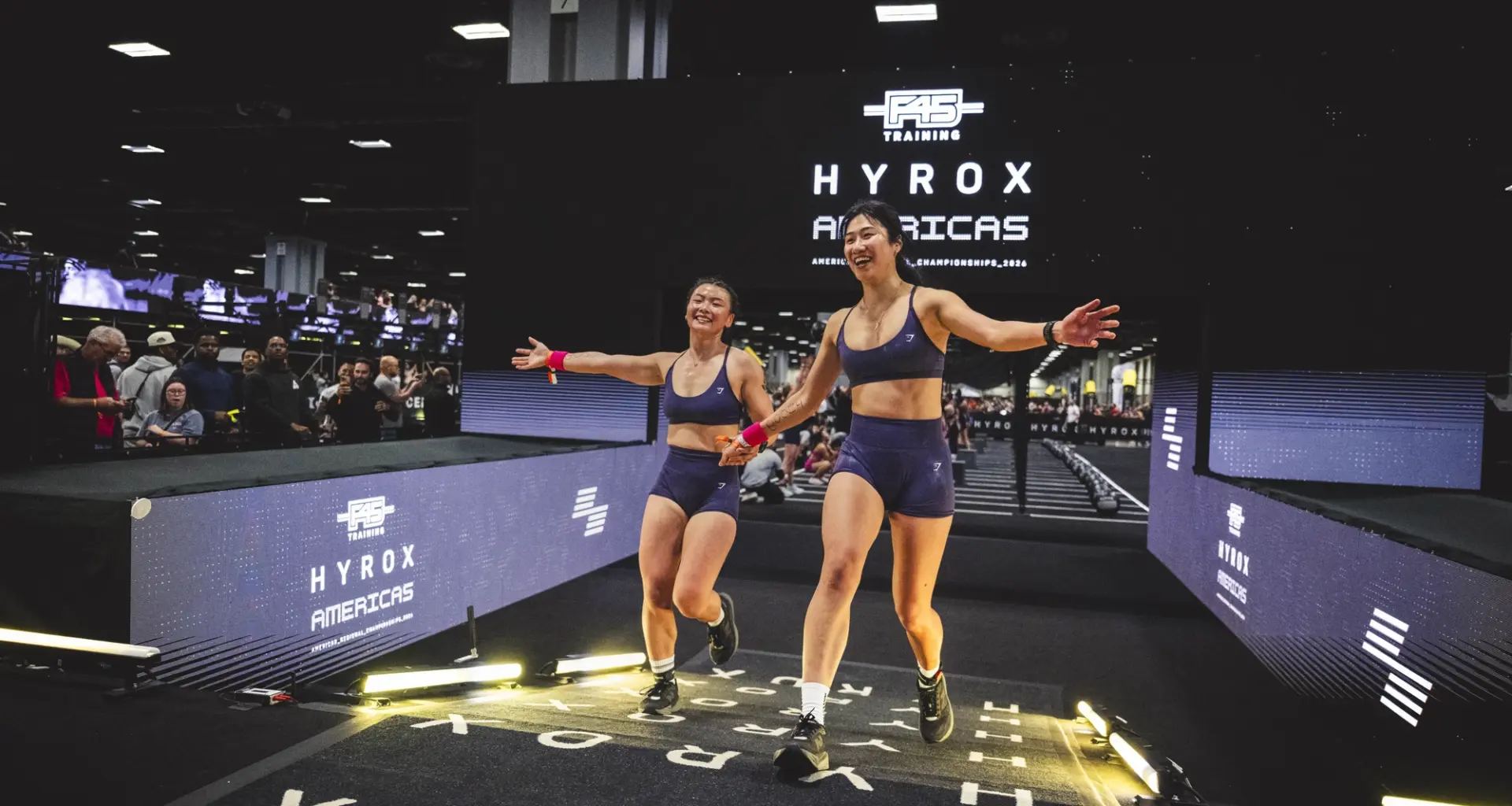 women cross the finish line at a Hyrox event