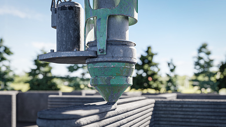 A concrete 3D printer building up a house