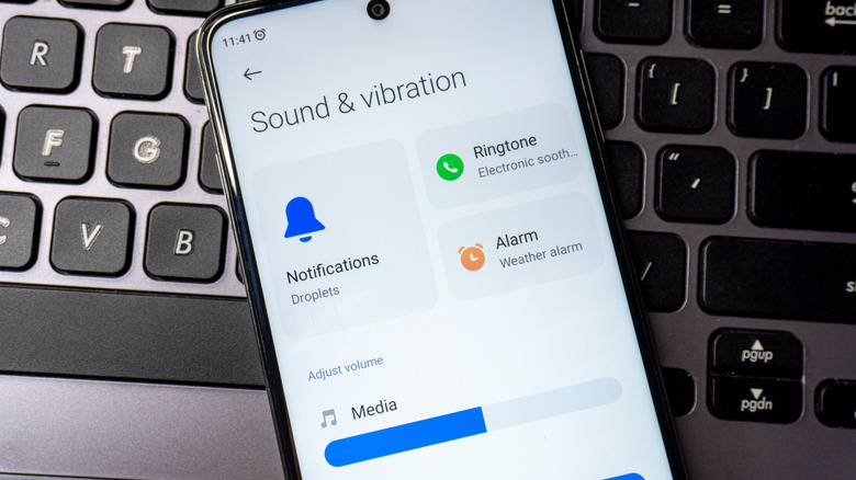 Sound and vibration settings open on an android smartphone that is placed on a laptop