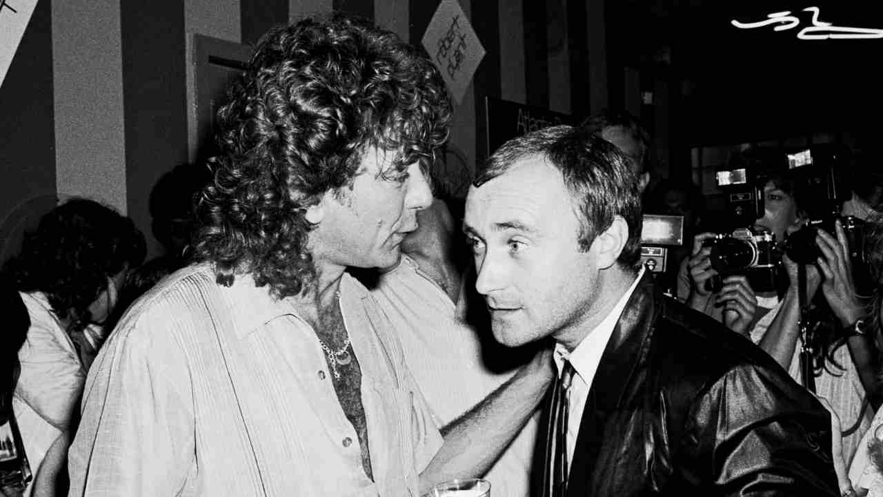 Robert Plant and Phil Collins talking at a party in 1983