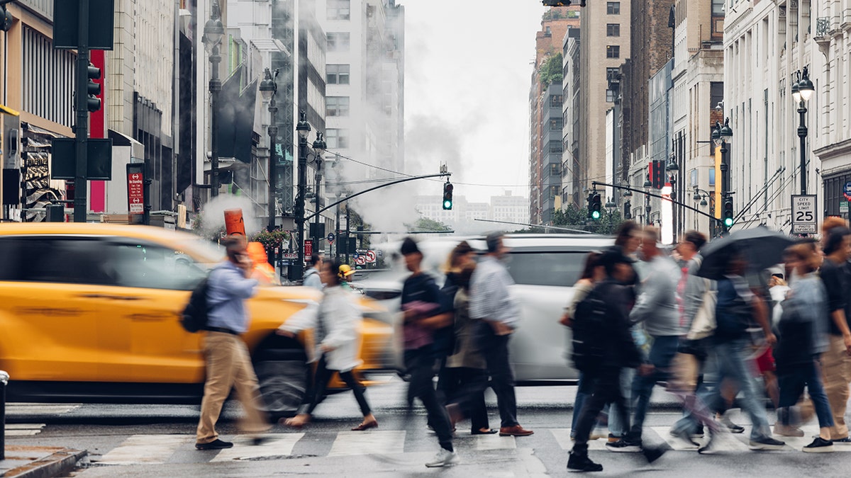 Busy crosswalk and road intersection in New York Manhattan