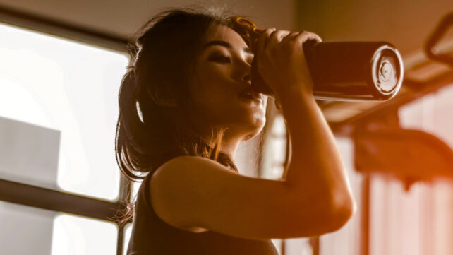woman drinking from a bottle